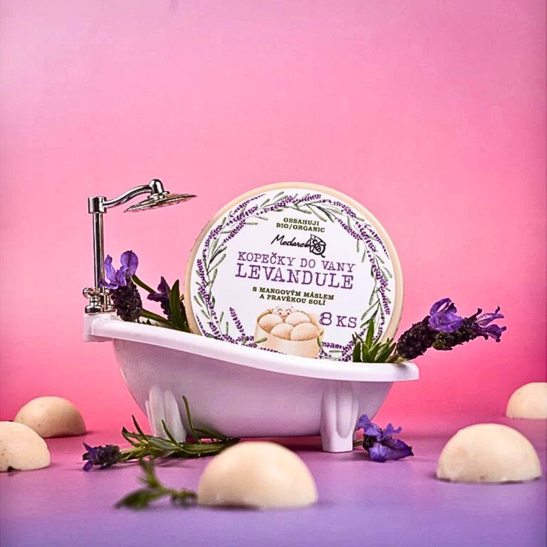 Medarek Lavender Bath Melts (8 pcs) tin in a miniature bathtub with fresh lavender on a pink–purple backdrop.